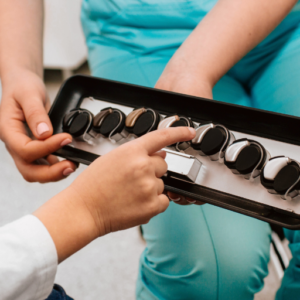 a patient picking a hearing aid from an array of options